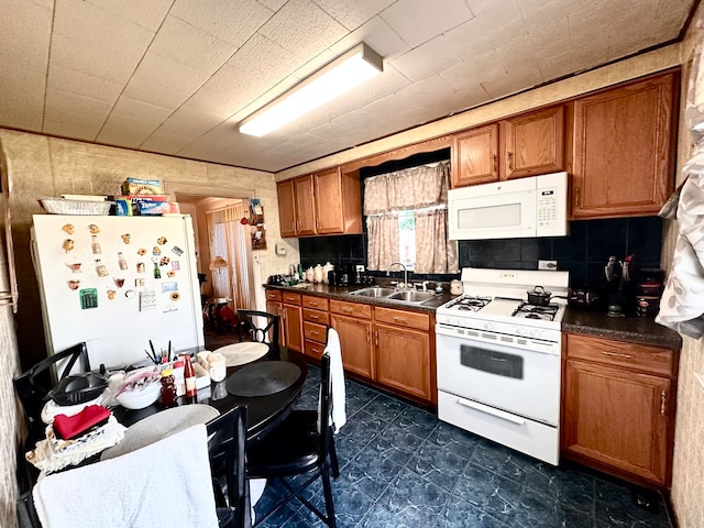 kitchen featuring decorative backsplash, sink, and white appliances