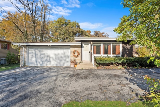 ranch-style home featuring a garage