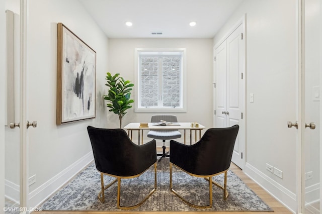 living area featuring light hardwood / wood-style floors and french doors