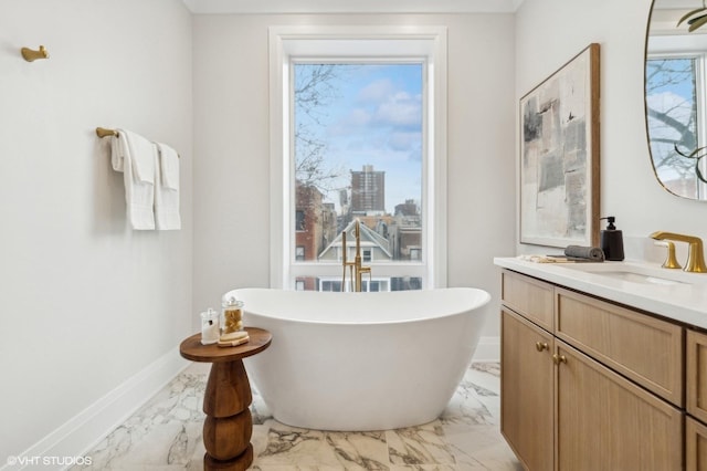 bathroom with vanity and a tub