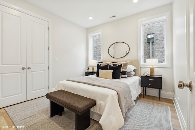 bedroom with a closet and light hardwood / wood-style flooring