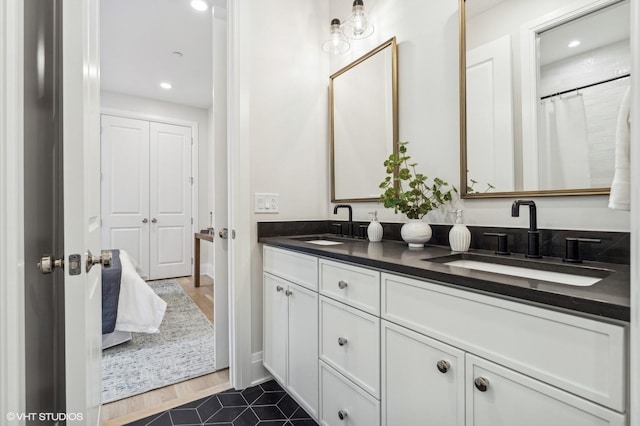 bathroom featuring tile patterned flooring and vanity