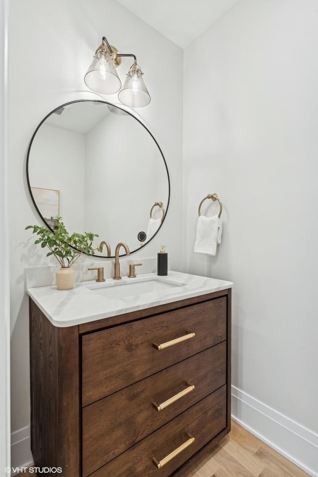 bathroom with hardwood / wood-style floors and vanity