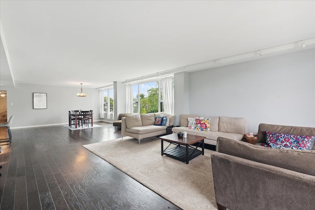 living room featuring hardwood / wood-style flooring, a chandelier, and rail lighting