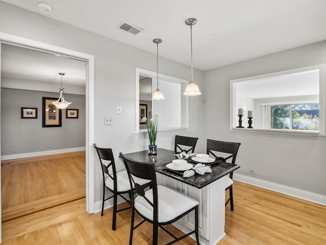 dining space featuring light wood-type flooring