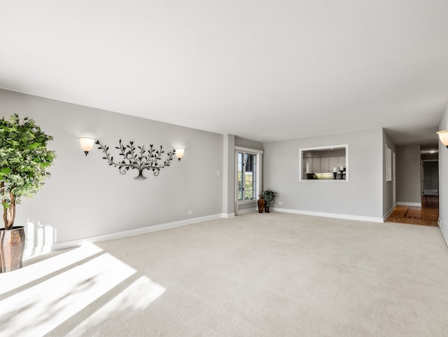 unfurnished living room with light colored carpet