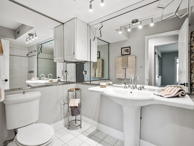 bathroom featuring toilet, tile patterned floors, and sink