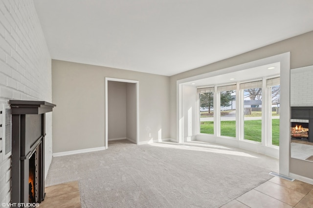 unfurnished living room featuring a fireplace and light colored carpet