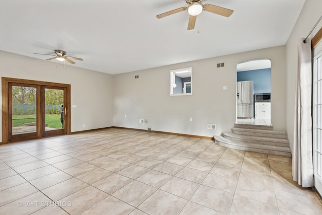 tiled empty room with ceiling fan