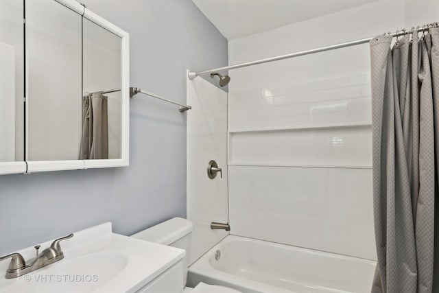 full bathroom featuring shower / bath combo, vanity, and toilet