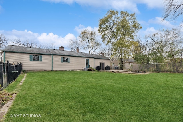 rear view of house featuring a lawn and central AC