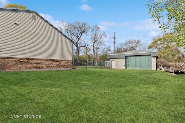 view of yard with a garage and an outdoor structure