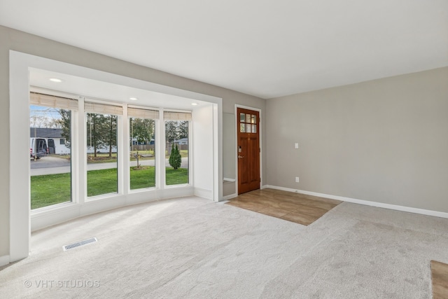 view of carpeted entrance foyer