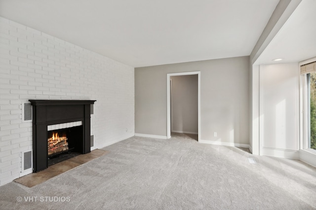 unfurnished living room featuring a wealth of natural light and carpet floors