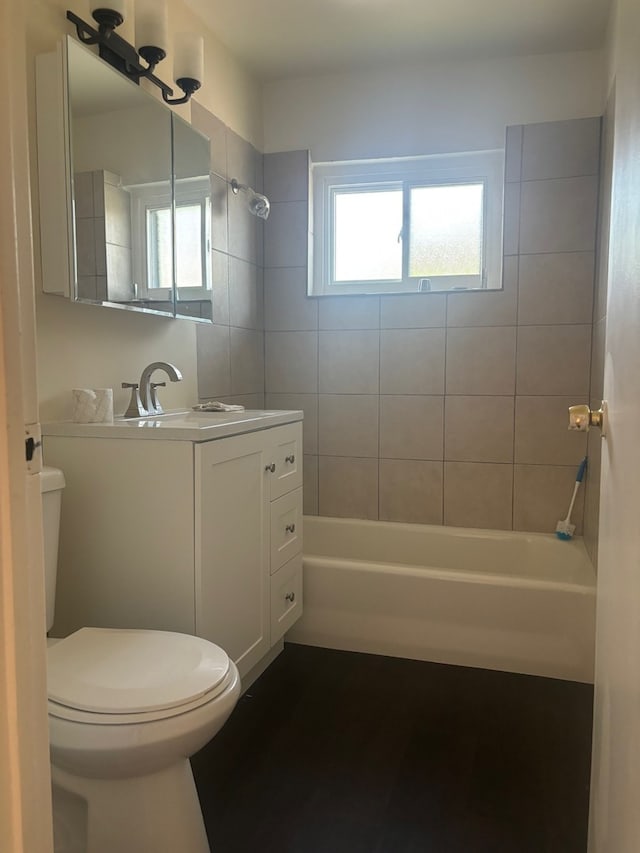 full bathroom featuring vanity, toilet, and tiled shower / bath