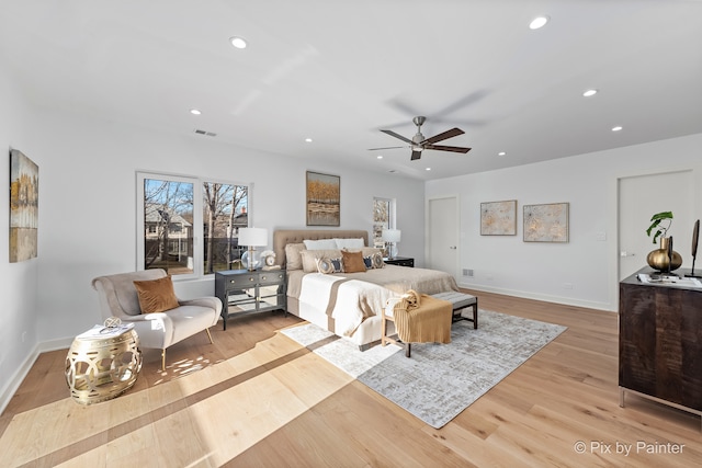 bedroom with light hardwood / wood-style flooring and ceiling fan