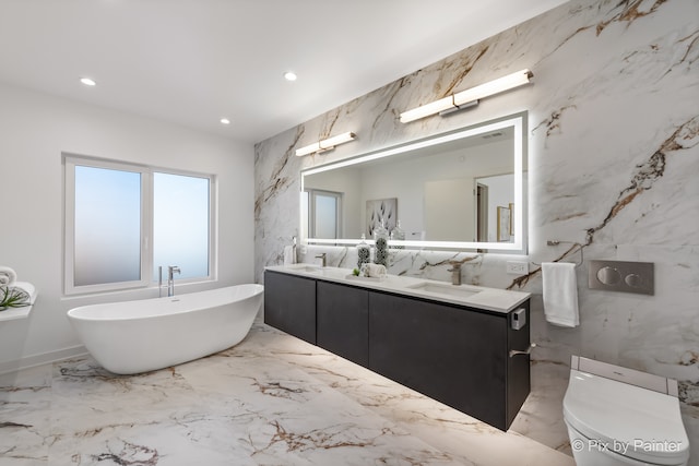 bathroom with vanity, a tub, toilet, and tile walls