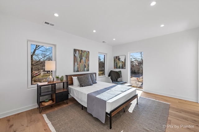 bedroom featuring multiple windows and light wood-type flooring