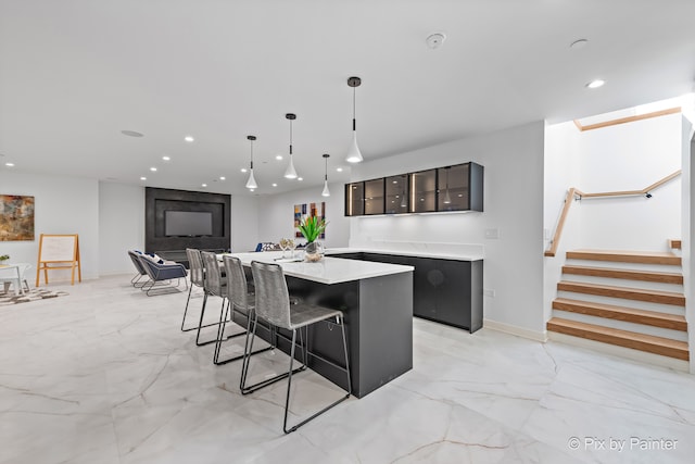 kitchen featuring a skylight, a breakfast bar area, and a kitchen island