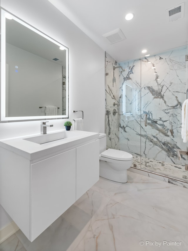 bathroom featuring vanity, toilet, and a shower with shower door