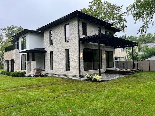 back of house featuring a wooden deck and a yard