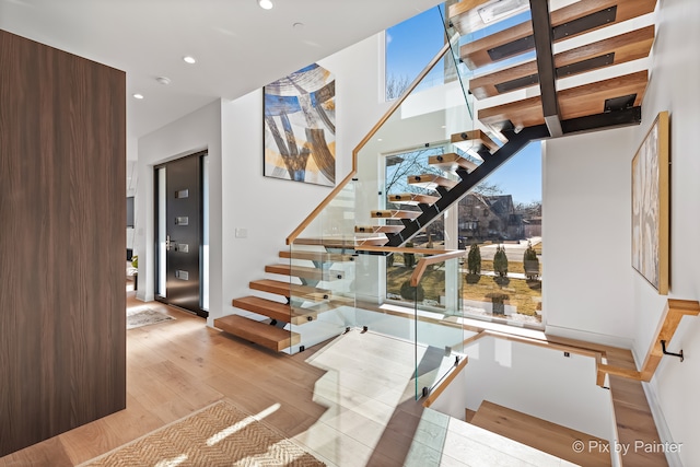 stairs with hardwood / wood-style floors