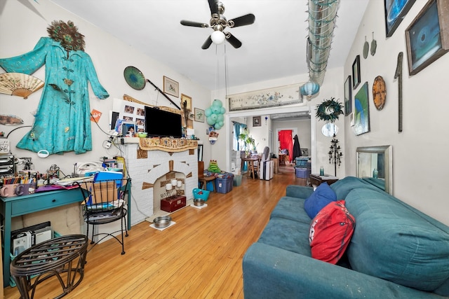 living room featuring ceiling fan and wood-type flooring