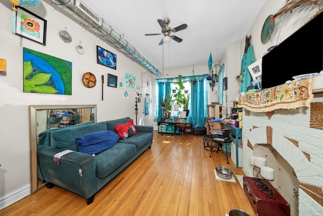 living room with wood-type flooring and ceiling fan