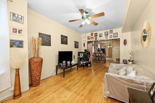 living room with ceiling fan and light wood-type flooring