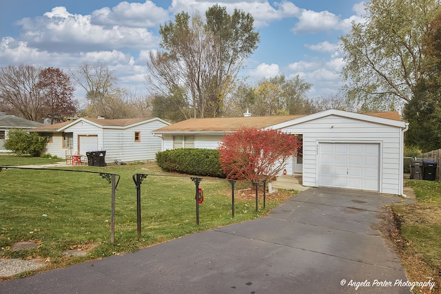 view of front of home with a front yard and a garage