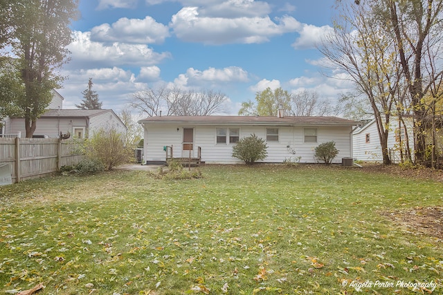 back of house with a lawn