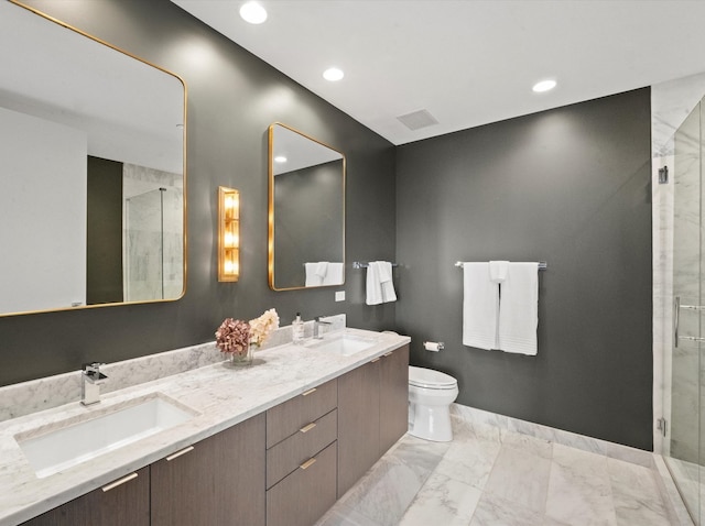 bathroom featuring vanity, toilet, and a shower with door