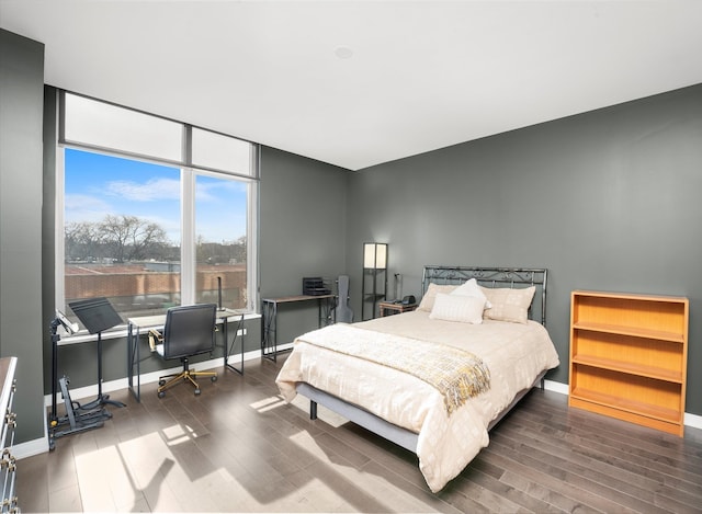 bedroom with dark hardwood / wood-style flooring