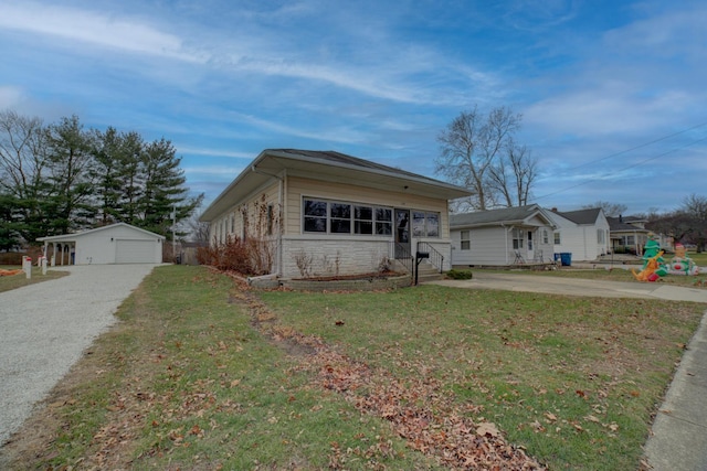 ranch-style house with a garage, an outdoor structure, and a front lawn