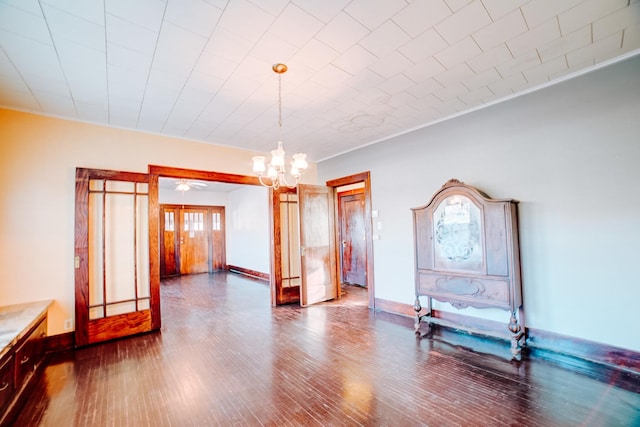 unfurnished dining area with ornamental molding, hardwood / wood-style floors, and an inviting chandelier