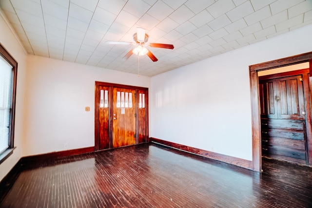 empty room with ceiling fan and dark hardwood / wood-style floors