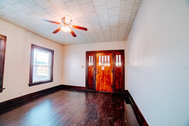 empty room featuring ceiling fan and dark hardwood / wood-style flooring