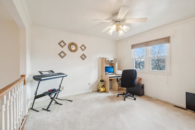 carpeted office with ceiling fan and crown molding