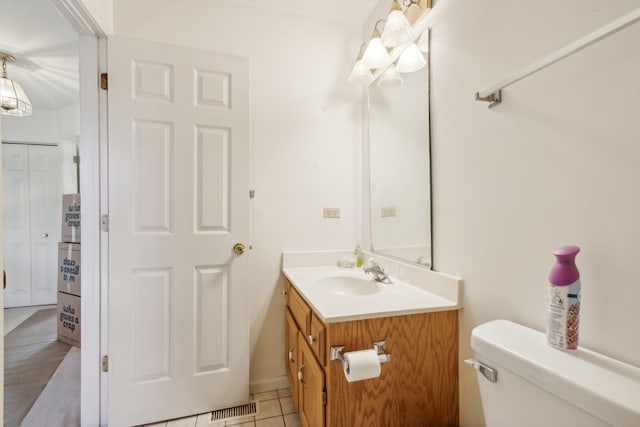 bathroom featuring vanity, toilet, and tile patterned flooring