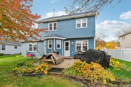 back of property with a patio area and a yard