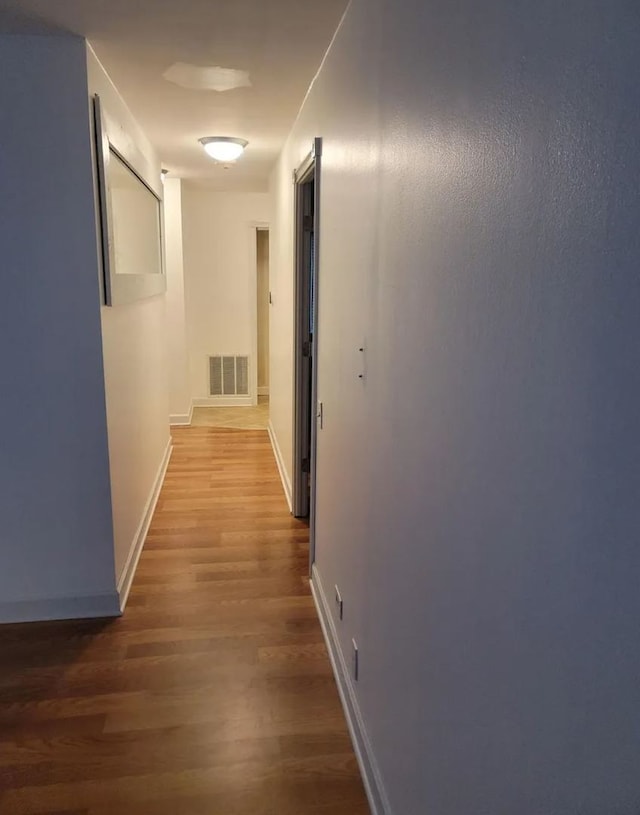 corridor with wood-type flooring