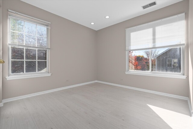 unfurnished room with light hardwood / wood-style flooring