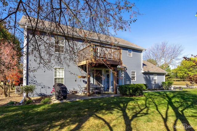 rear view of house featuring a patio area and a yard