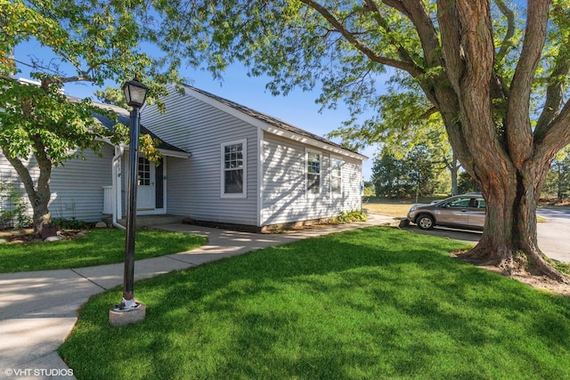 view of property exterior with a yard