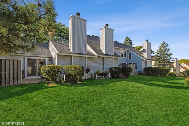 back of property featuring a yard