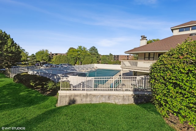 view of pool featuring a yard