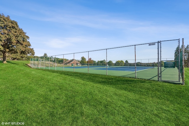 view of sport court featuring a yard