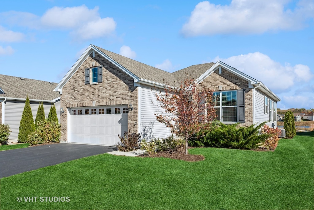 view of front of property featuring a garage and a front yard