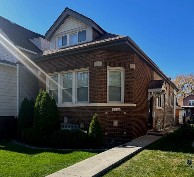 view of side of property with a lawn