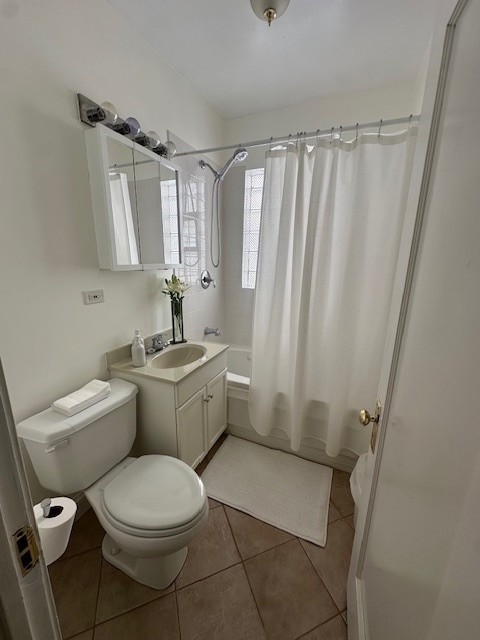 full bathroom with vanity, shower / bath combo, toilet, and tile patterned flooring